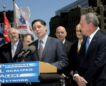 With Manhattan as a backdrop, Genachowski in May 2011 announced a new public safety system that sends geographically targeted alerts to enabled mobile devices. NYPD Commissioner Raymond Kelly and NYC Mayor Michael Bloomberg stand at far right. PHOTO: FCC